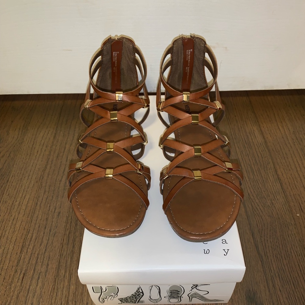 Tan strappy sandal with gold accents.